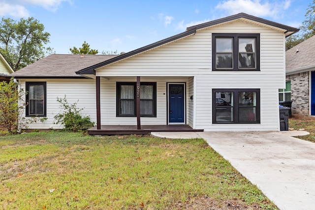 view of front of house with a front yard and a porch