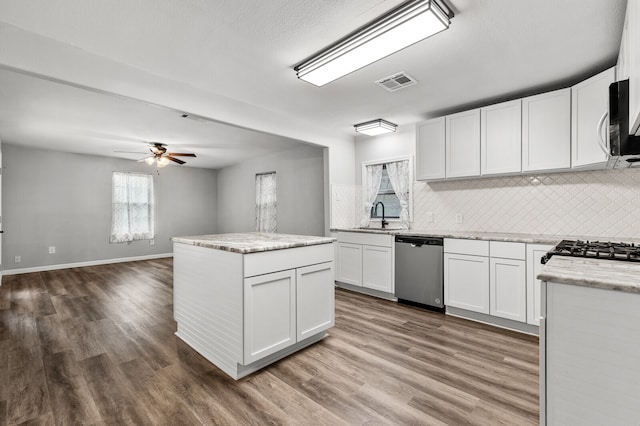 kitchen featuring dark hardwood / wood-style flooring, appliances with stainless steel finishes, and white cabinets