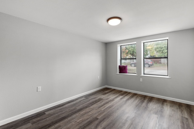 spare room featuring dark hardwood / wood-style flooring