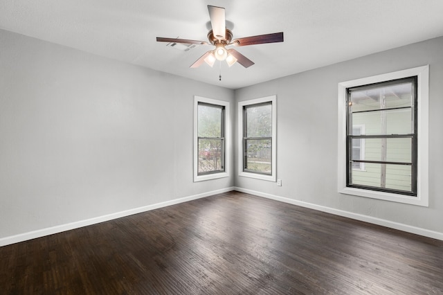 unfurnished room featuring dark wood-type flooring and ceiling fan