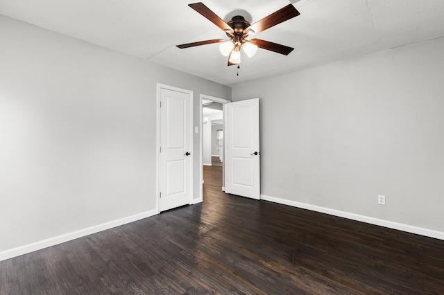 spare room featuring dark hardwood / wood-style flooring and ceiling fan