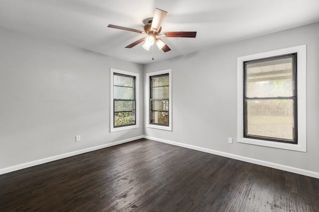 spare room featuring ceiling fan and dark hardwood / wood-style floors