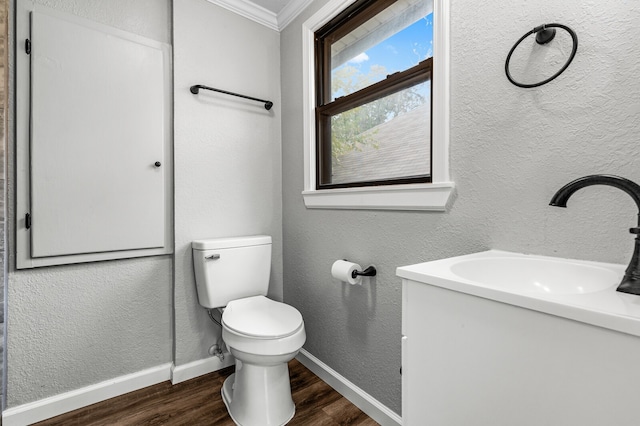 bathroom with hardwood / wood-style floors, vanity, toilet, and crown molding