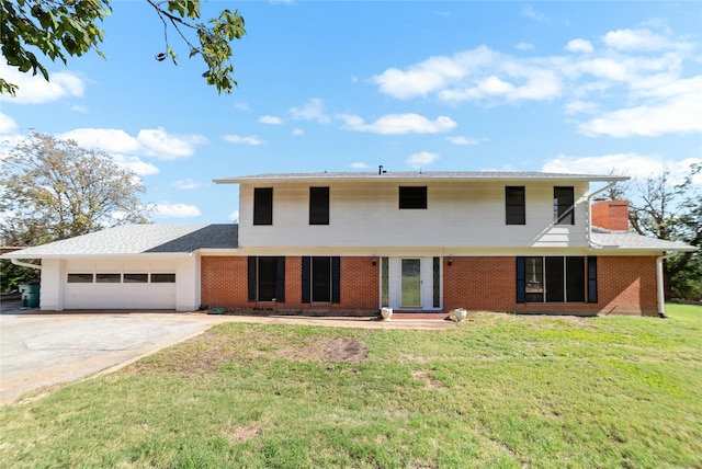 view of front of home featuring a front lawn and a garage