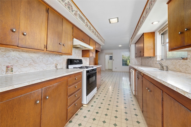 kitchen with tasteful backsplash, sink, and white appliances