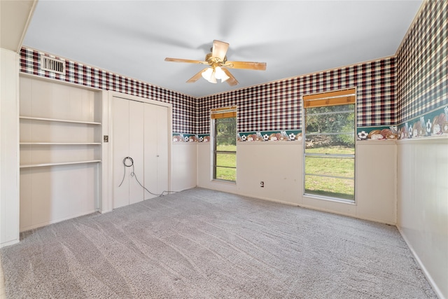 unfurnished bedroom featuring carpet flooring, ceiling fan, and a closet