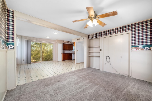 unfurnished bedroom featuring a closet, light carpet, and ceiling fan