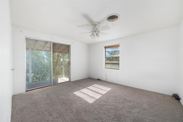 carpeted spare room featuring ceiling fan