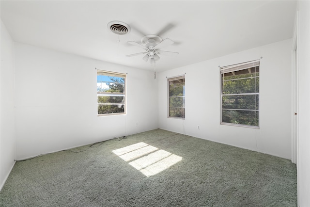 empty room featuring ceiling fan and carpet floors