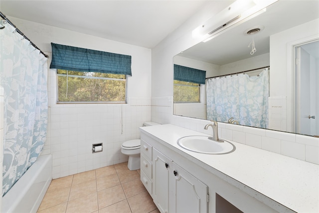 full bathroom featuring toilet, tile patterned floors, tile walls, vanity, and shower / bathtub combination with curtain