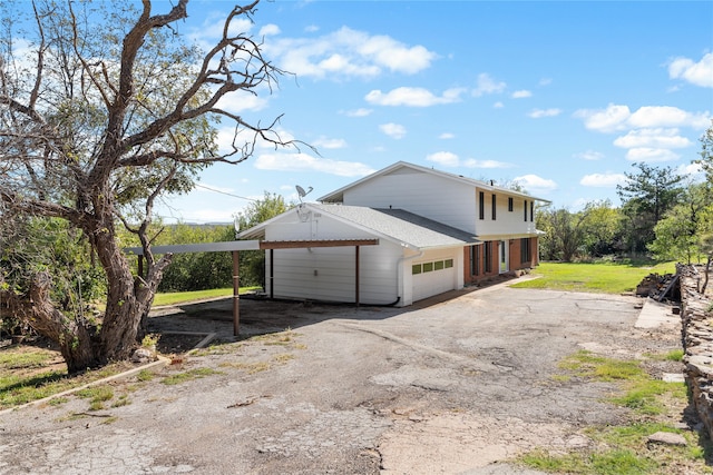 view of property exterior with a yard and a carport