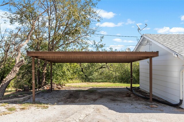 view of vehicle parking with a carport