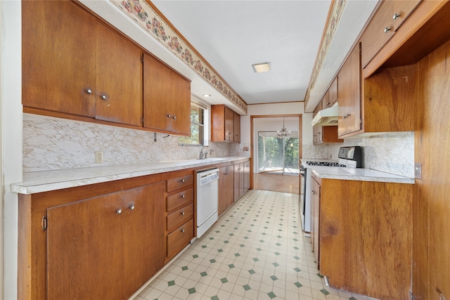 kitchen with white appliances, sink, and tasteful backsplash