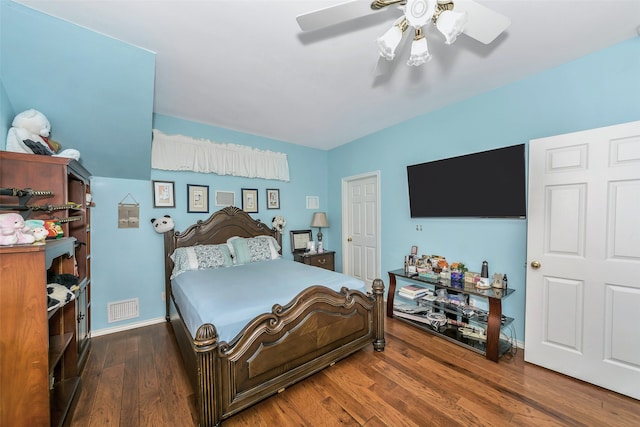 bedroom with dark hardwood / wood-style flooring and ceiling fan