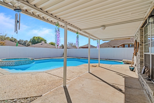 view of swimming pool featuring an in ground hot tub and a patio area