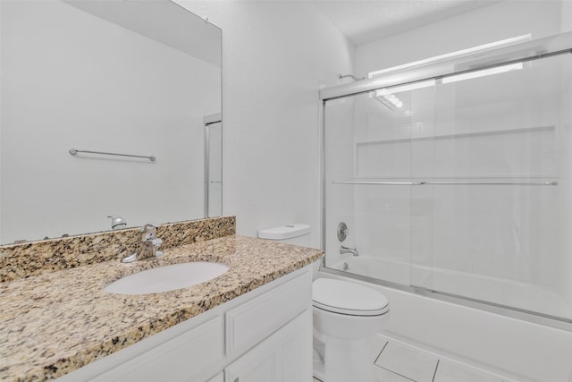 full bathroom featuring tile patterned flooring, shower / bath combination with glass door, toilet, and vanity