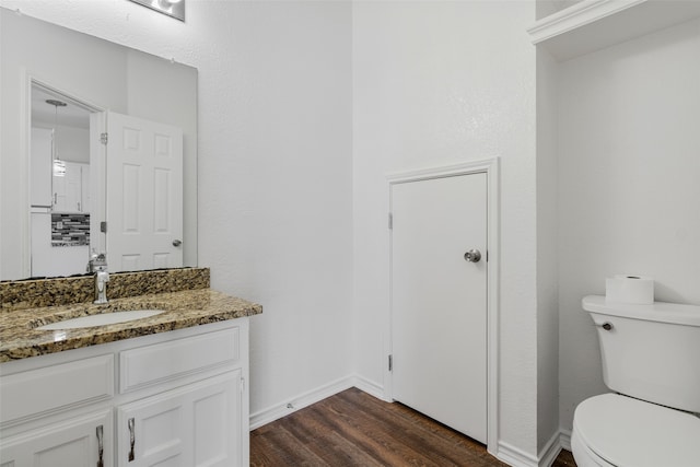 bathroom featuring hardwood / wood-style floors, vanity, and toilet