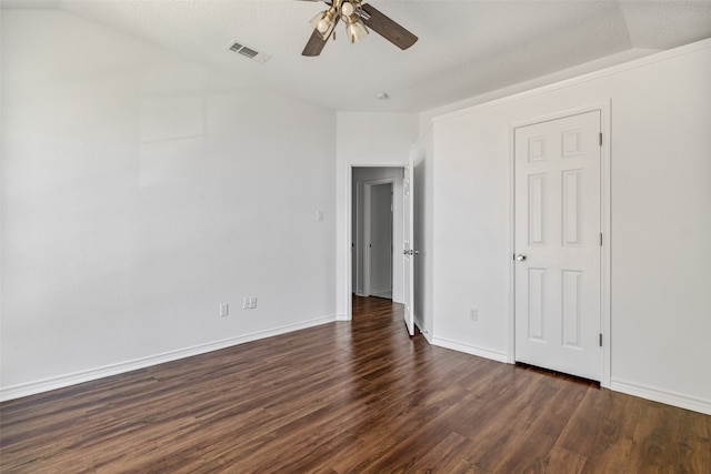 unfurnished bedroom with a textured ceiling, dark wood-type flooring, ceiling fan, and lofted ceiling