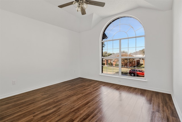 unfurnished room with dark hardwood / wood-style flooring, lofted ceiling, a textured ceiling, and ceiling fan