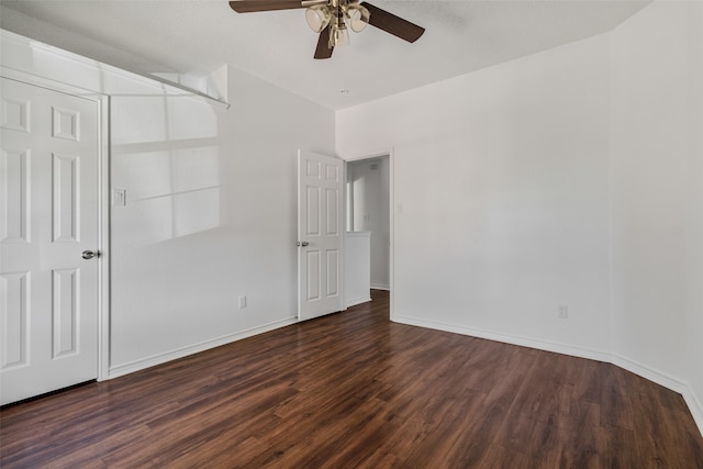 unfurnished bedroom with dark wood-type flooring and ceiling fan