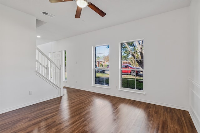 empty room with dark hardwood / wood-style flooring and ceiling fan