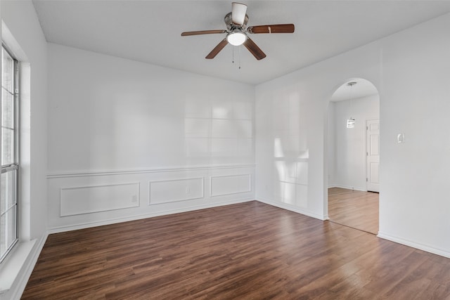 unfurnished room with ceiling fan, hardwood / wood-style flooring, and a healthy amount of sunlight