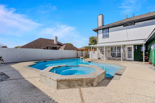 view of swimming pool with an in ground hot tub and a patio area