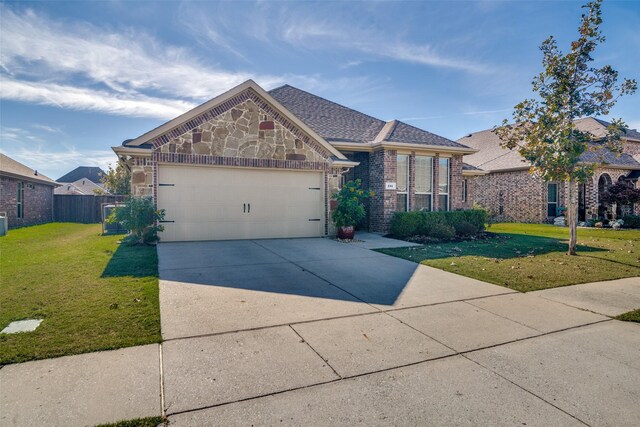 view of front of home with a garage and a front lawn