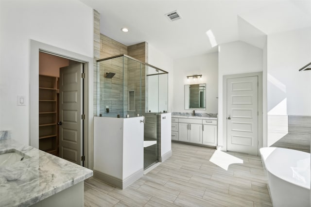 bathroom featuring vanity and plus walk in shower