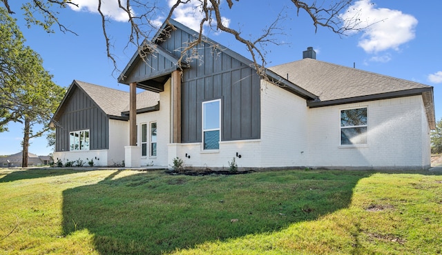 rear view of house featuring a lawn