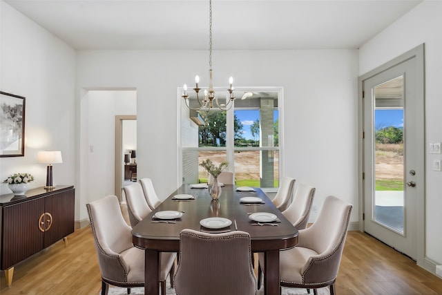 dining room featuring light hardwood / wood-style floors and a chandelier