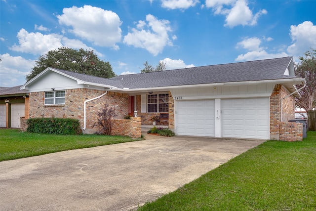 ranch-style home with a garage and a front lawn