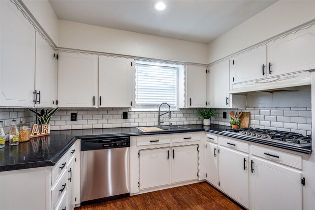 kitchen featuring stainless steel appliances, white cabinetry, sink, dark wood-type flooring, and decorative backsplash