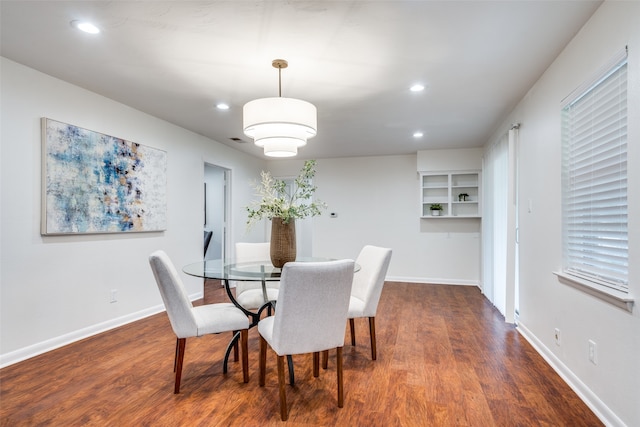 dining space with dark hardwood / wood-style flooring