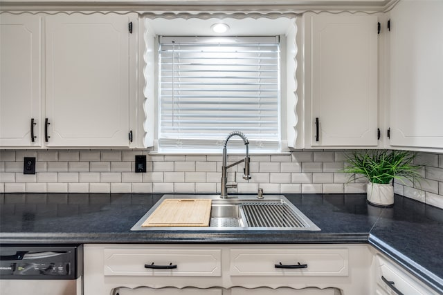 kitchen with white cabinets, sink, and tasteful backsplash