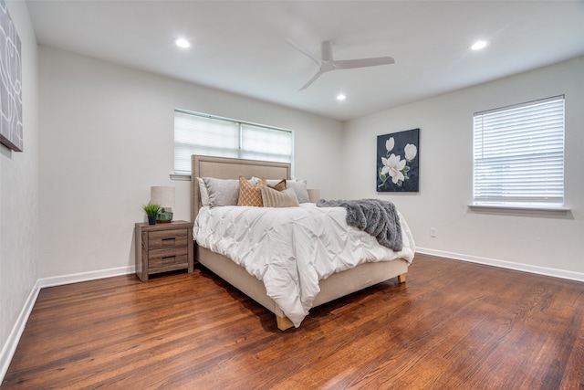 bedroom with dark hardwood / wood-style floors and ceiling fan