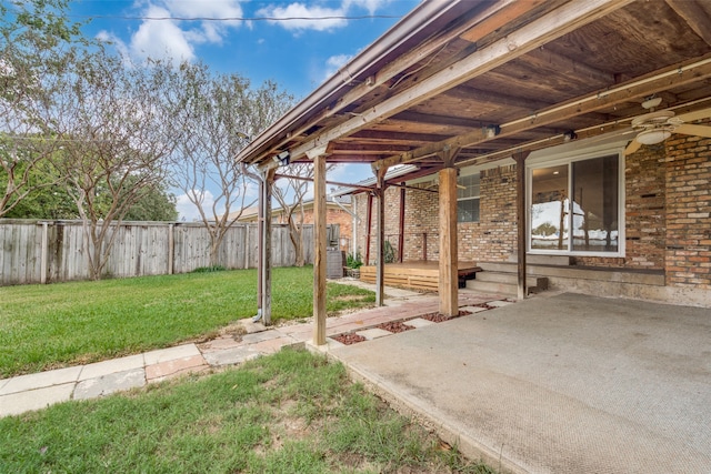 view of yard with ceiling fan and a patio area