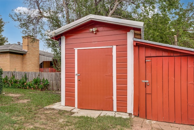 view of outbuilding with a yard