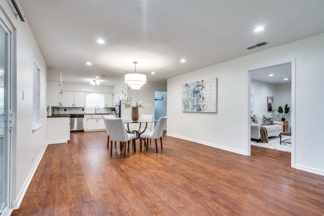 dining area featuring dark hardwood / wood-style flooring and sink