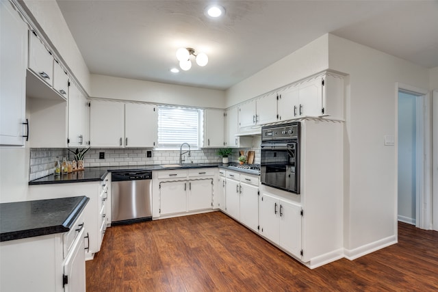 kitchen featuring dark hardwood / wood-style floors, white cabinetry, decorative backsplash, and appliances with stainless steel finishes