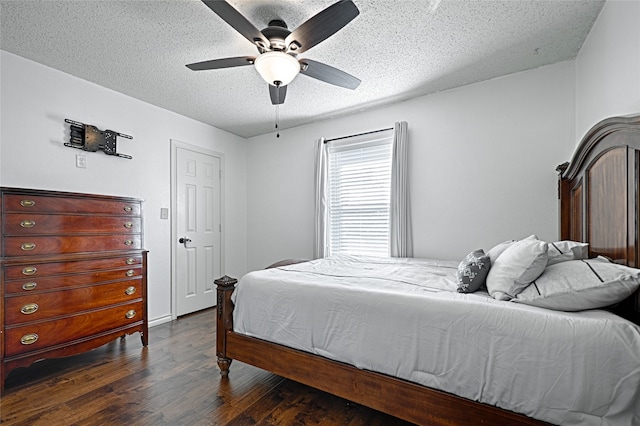 bedroom featuring a textured ceiling, dark hardwood / wood-style floors, and ceiling fan