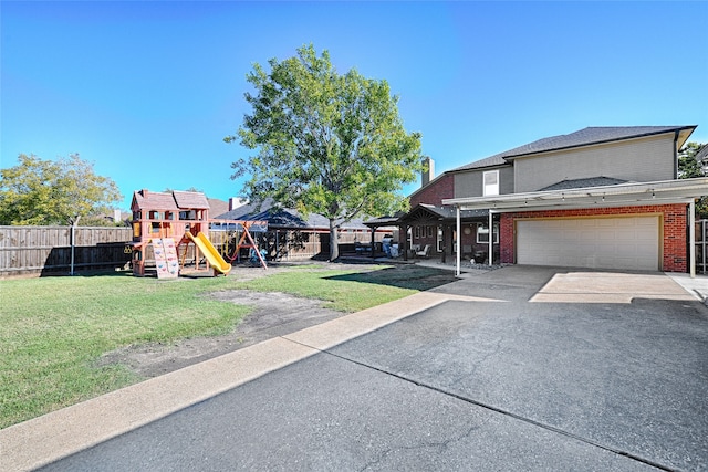 view of yard featuring a playground and a garage