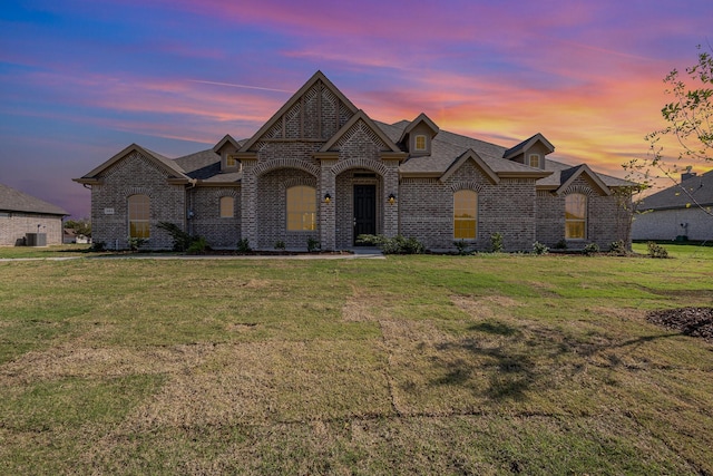 french country home with a lawn