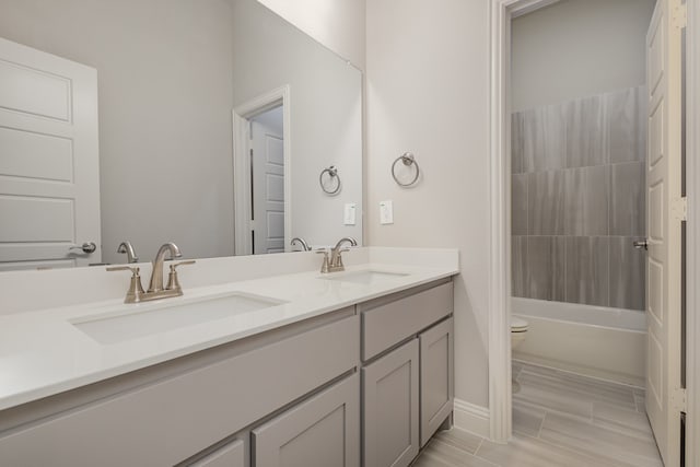 full bathroom with toilet, vanity, wood-type flooring, and bathing tub / shower combination