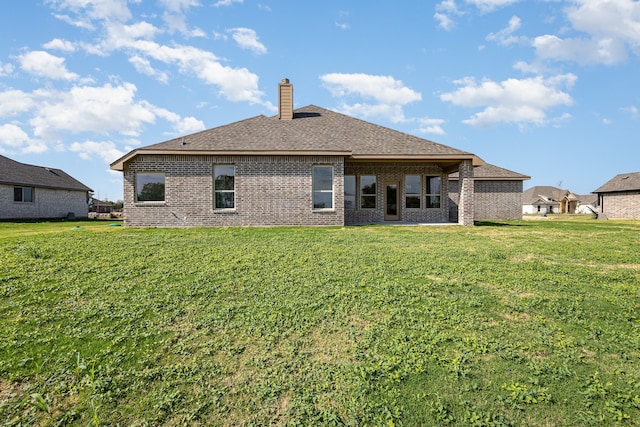 rear view of property featuring a yard