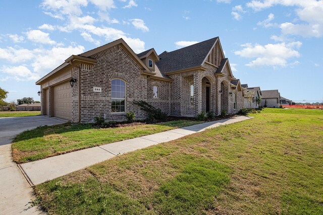 view of front of home with a garage and a front yard