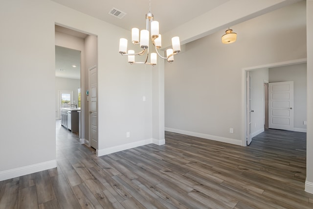 unfurnished dining area with dark hardwood / wood-style flooring, a chandelier, and sink