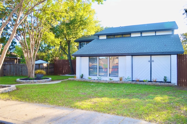 back of house featuring a storage shed and a lawn