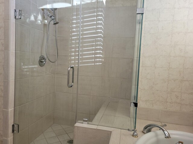 bathroom featuring separate shower and tub