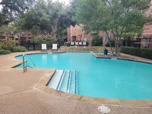 view of swimming pool featuring a patio area